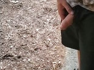 Boy peeing outside cabin