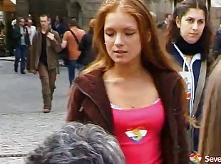 Cute redhead walks along the streets of prague