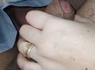 Stepmom close-up jerks off under the blanket, causing her stepson to have an erection
