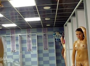 Naked girl with beautiful tan lines takes a shower.