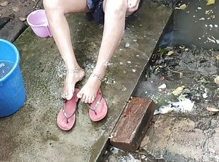 Indian house wife bathing outside