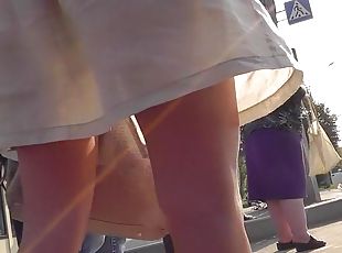 Sexy upskirt on the street with leggy brunette